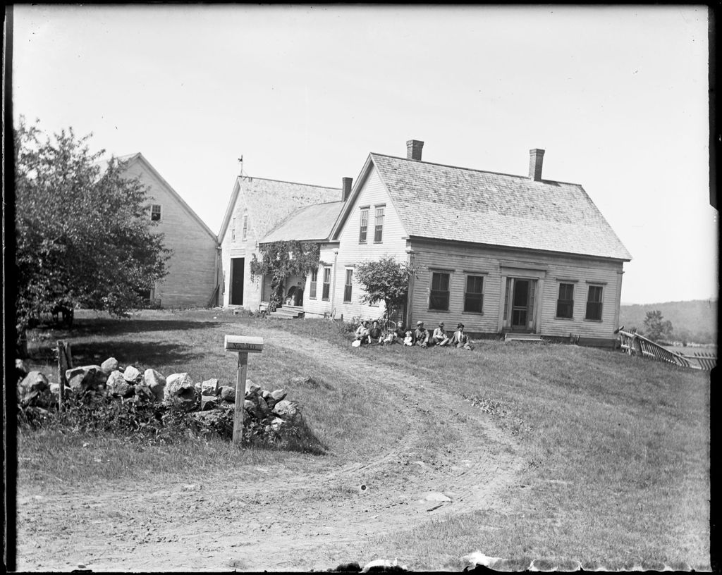 Miniature of Family Sitting Outside A Farmhouse With Attached Barn
