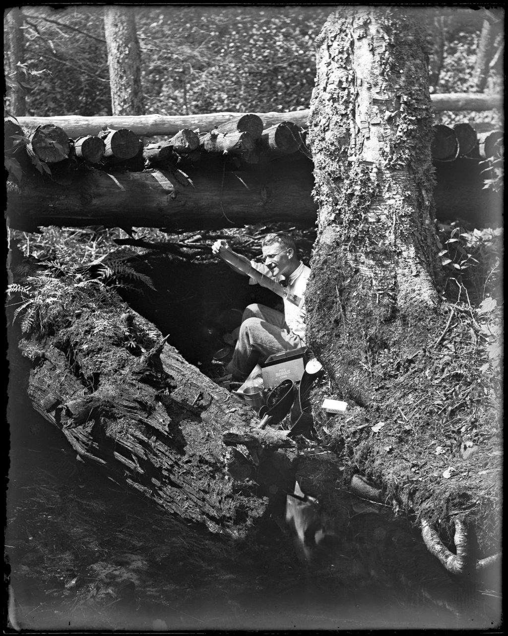 Miniature of George French Under A Wooden Bridge Looking At A Film Strip