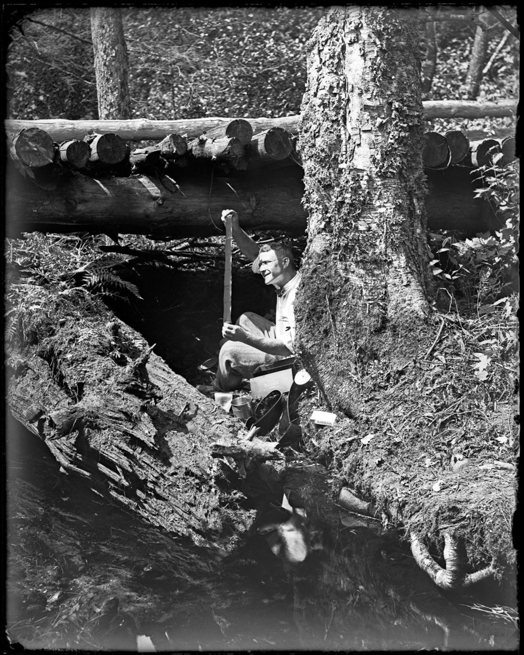 Miniature of George French Under A Wooden Bridge Looking At A Film Strip