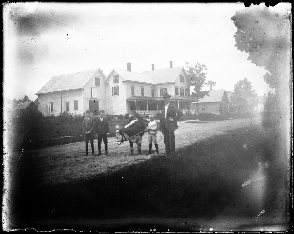Miniature of Man And Three Children Posed With A Cow Outside Their Rural Home