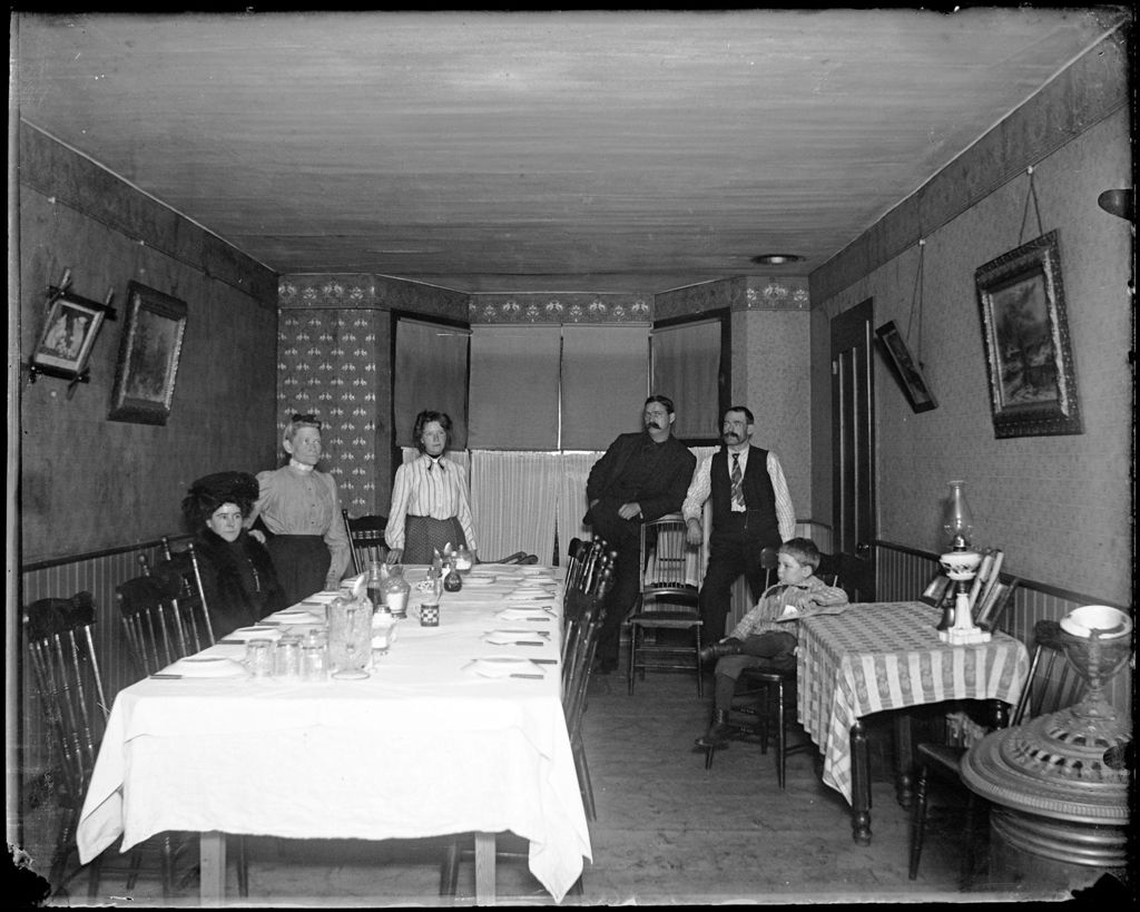 Miniature of Family Collected In A Dining Room At A Set Table