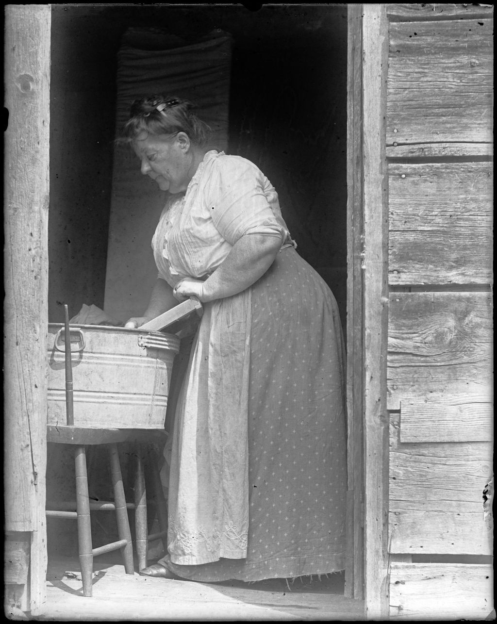 Miniature of Older Woman Doing The Wash