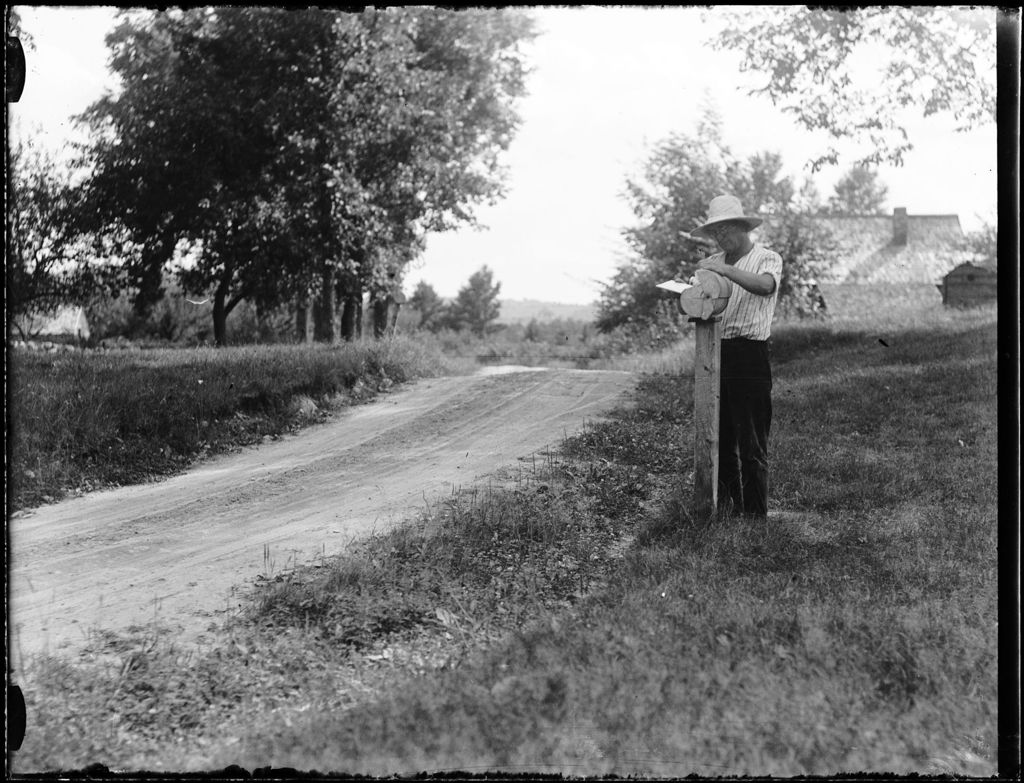 Miniature of Man Getting Mail From A Rural Roadside Mailbox