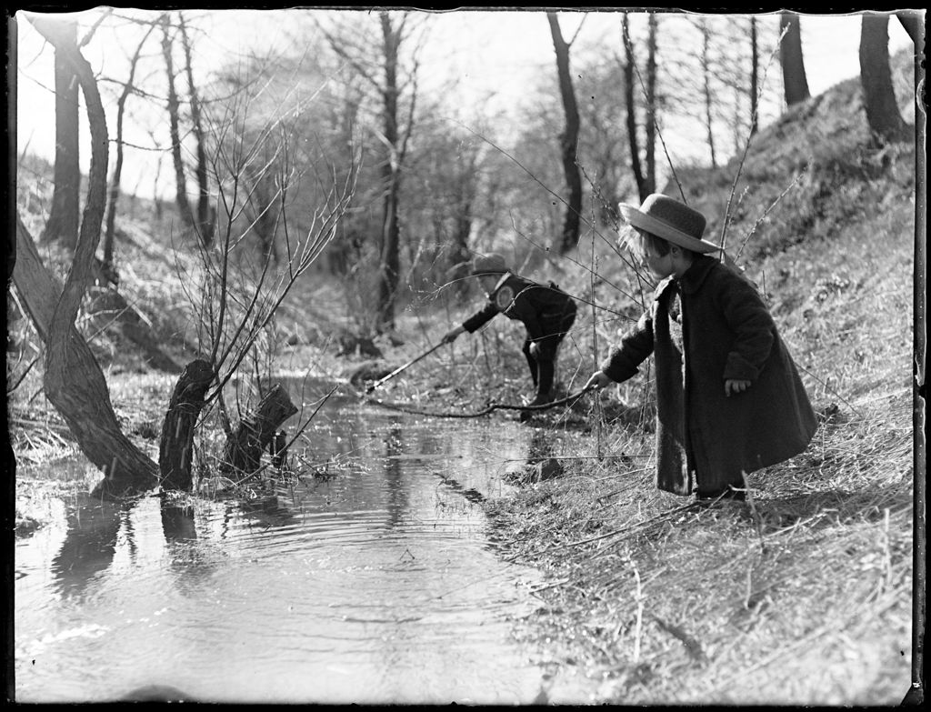 Miniature of Young Boy And Girl With Sticks Playing Beside A Stream