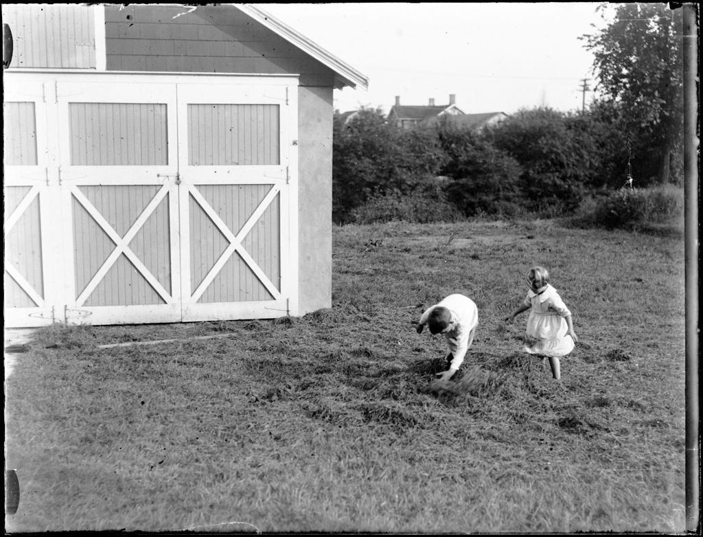 Miniature of Young Boy And Girl Playing In Cut Hay Outside Of A Barn