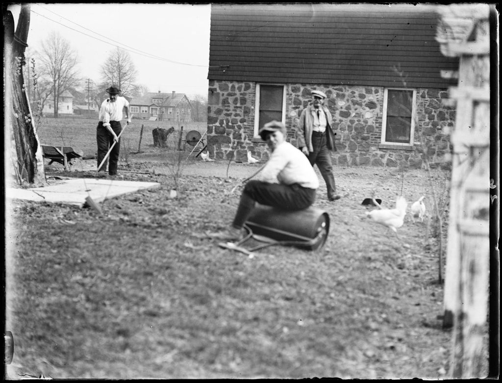 Miniature of Three People In The Back Yard Of A House