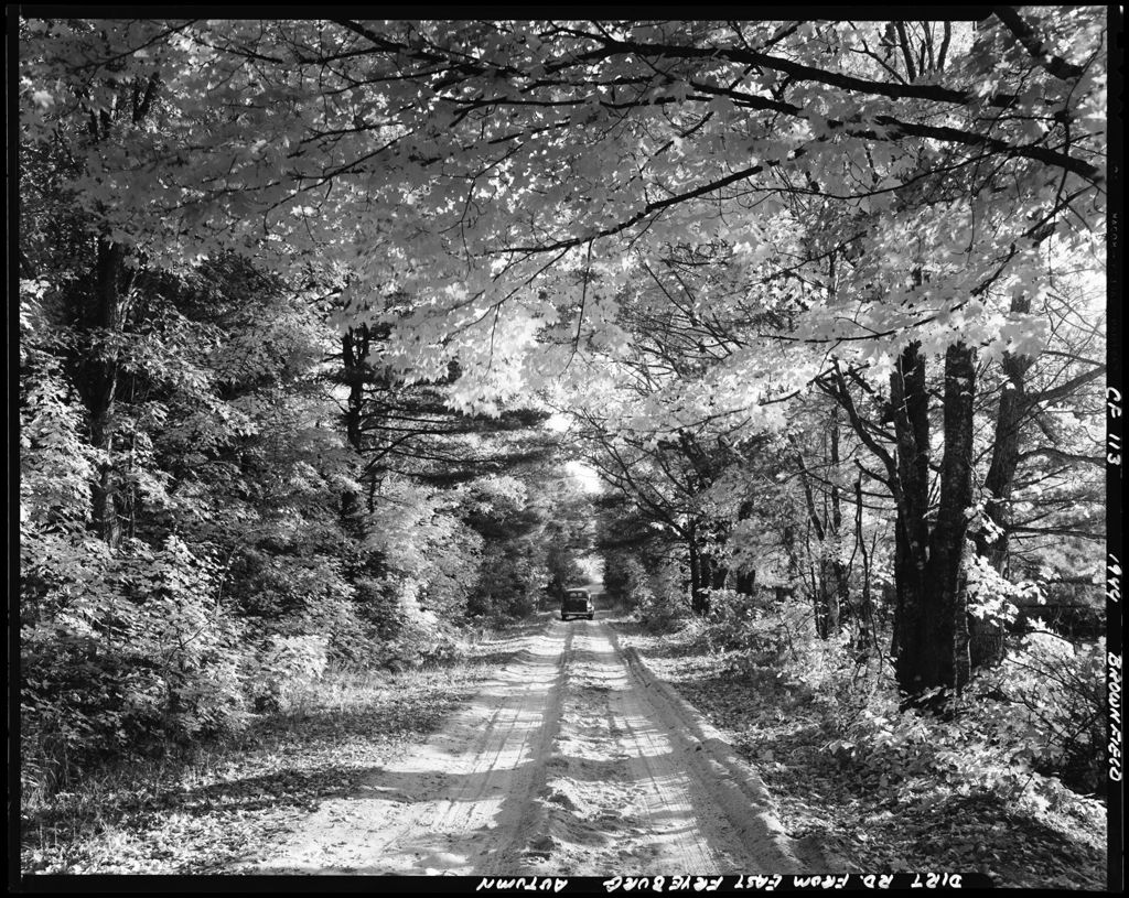 Miniature of A Car Driving Down A Country Road In Brownfield
