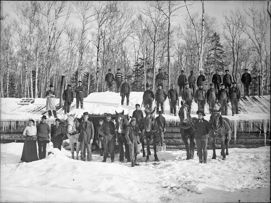 Miniature of Snow covered winter scene of many men at a logging camp