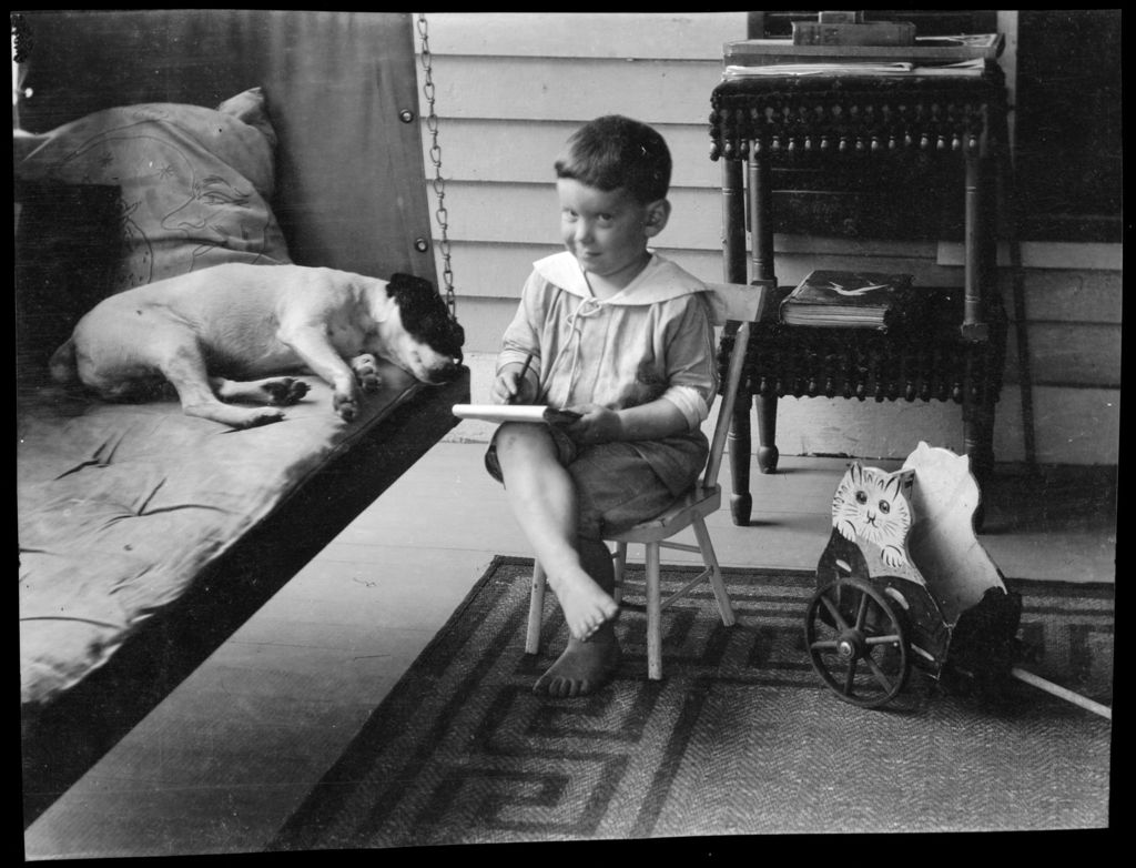Miniature of Tots- Don F. Writes On Don Nevins Piazza. He Sits With Dog On Bed