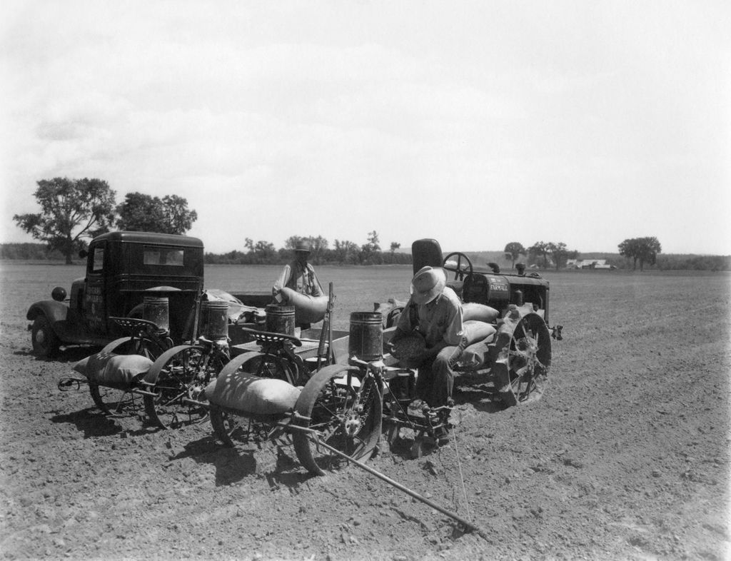 Miniature of Workers Seeding Cornfield With Machine
