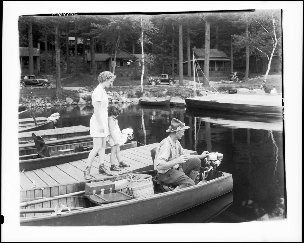 Miniature of Man In Canoe Getting Ready To Go Out Fishing, Two Girls Looking On