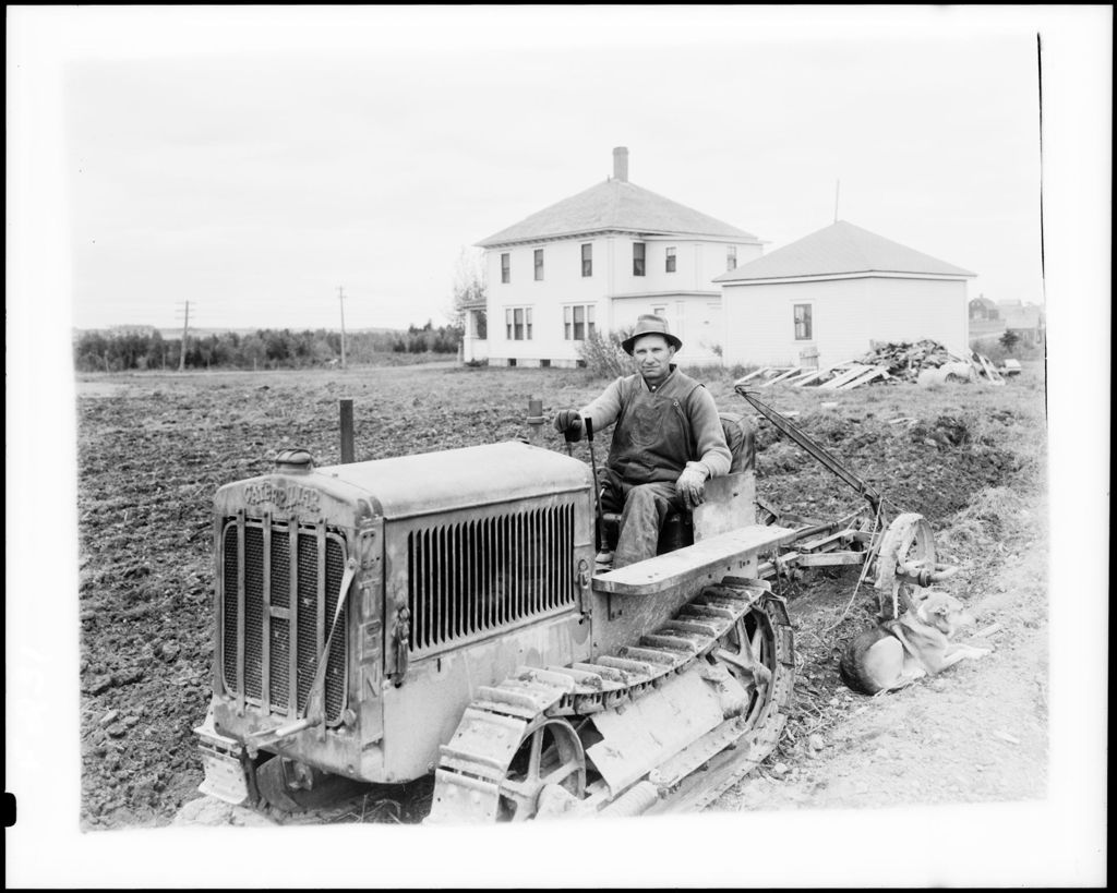 Miniature of Farmer On A "Caterpillar" Tractor Preparing To Work A Field
