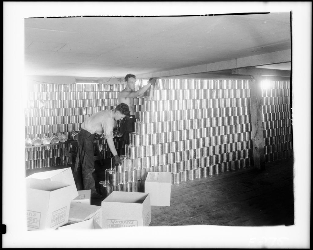 Miniature of Two Men Stacking Cans Of Blueberries