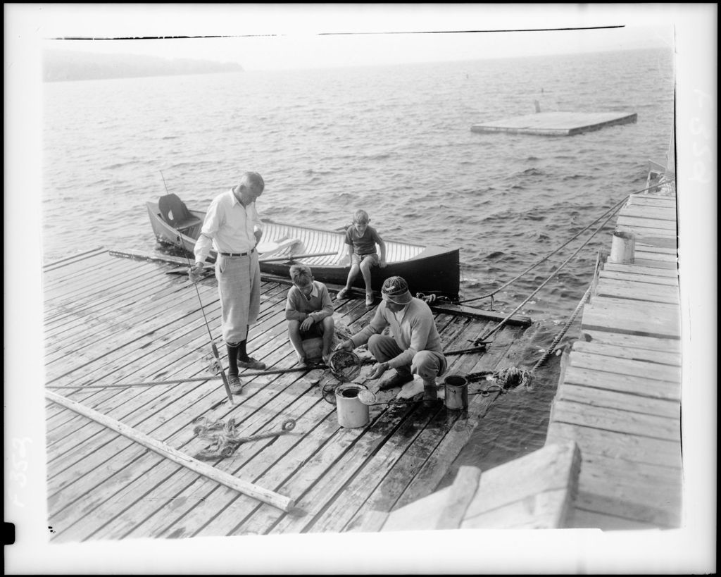 Miniature of Man On Dock Dumping Bait Into A Bait Can Getting Ready For Fishing