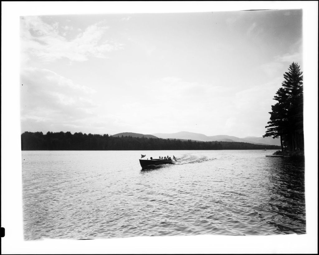 Miniature of Motor Boat Full Of People On A Lake With Mountains In The Background