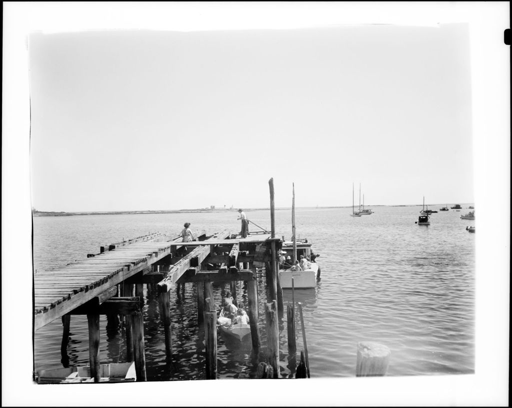 Miniature of Shot Down Pier Toward Ocean, People Standing On Pier And Boats Tied In At Same At Cape Porpoise