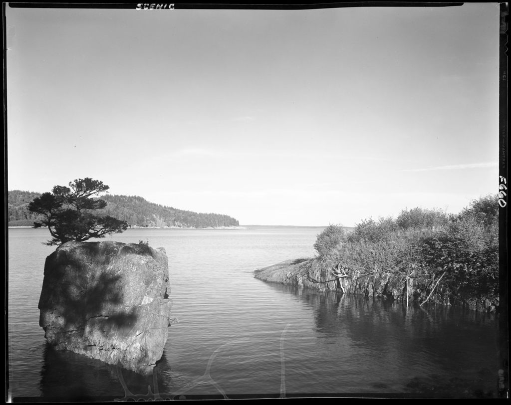 Miniature of Large Rock With Tree Growing On Top In Foreground Of A Cove On The Coast