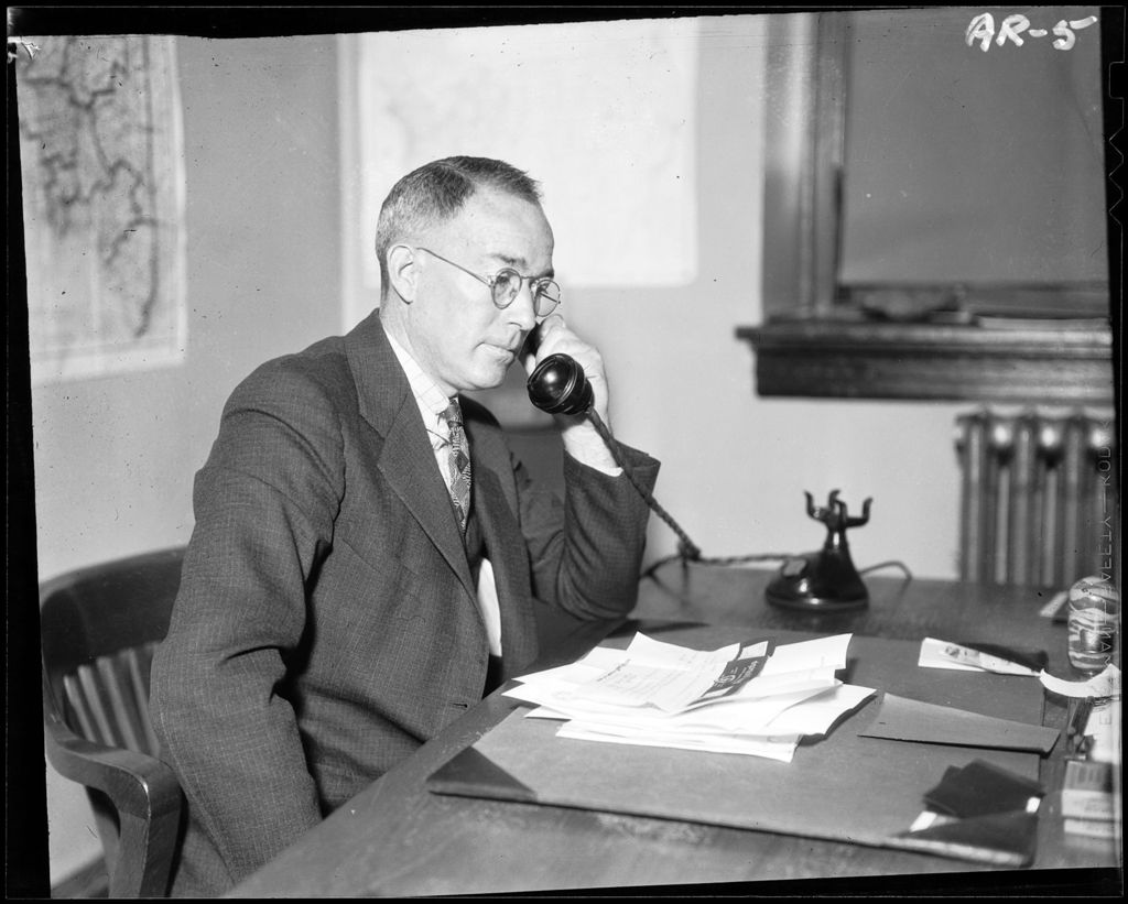 Miniature of Man Talking On A Telephone
