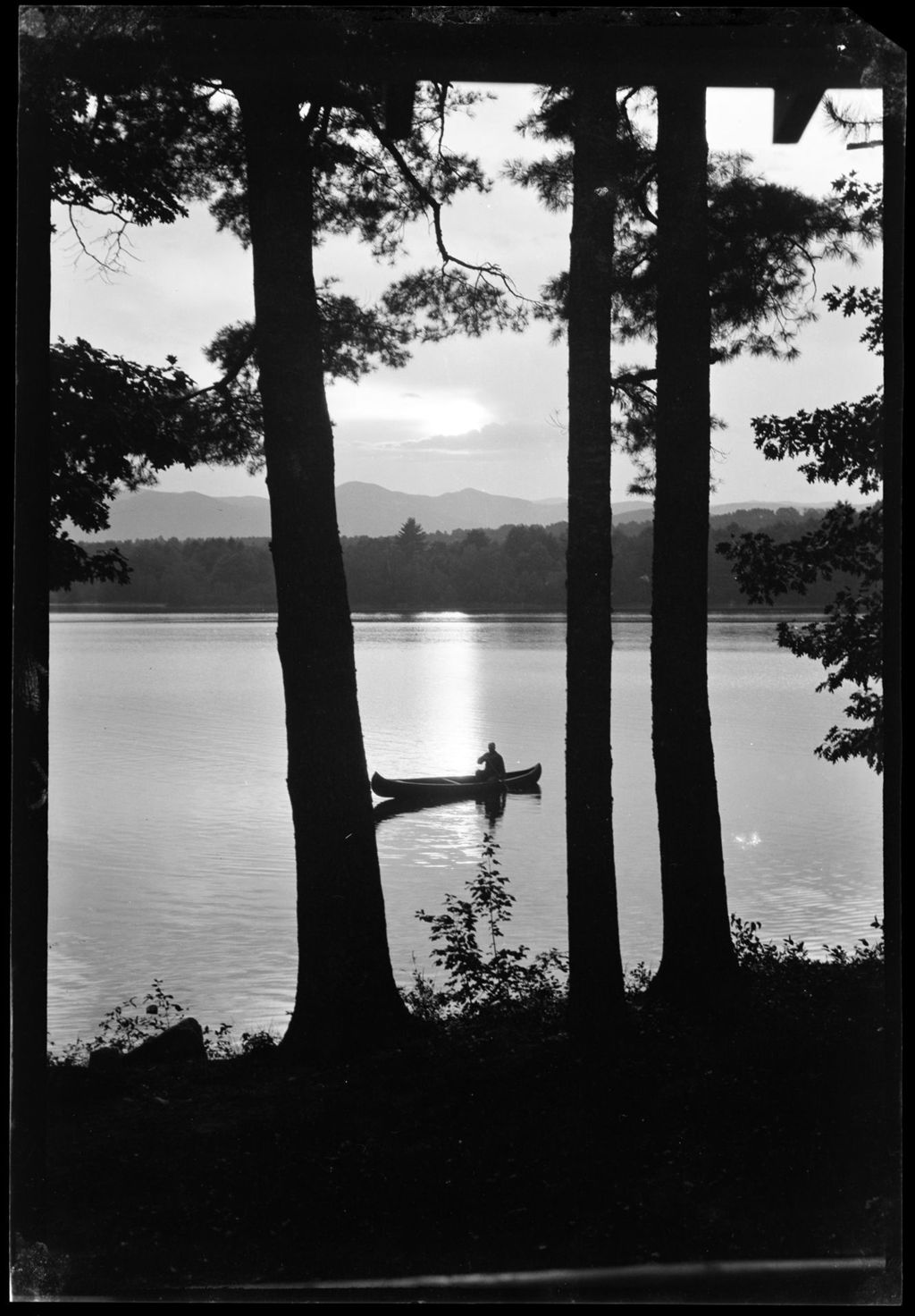 Miniature of A Person Canoeing On A Lake At Sunset