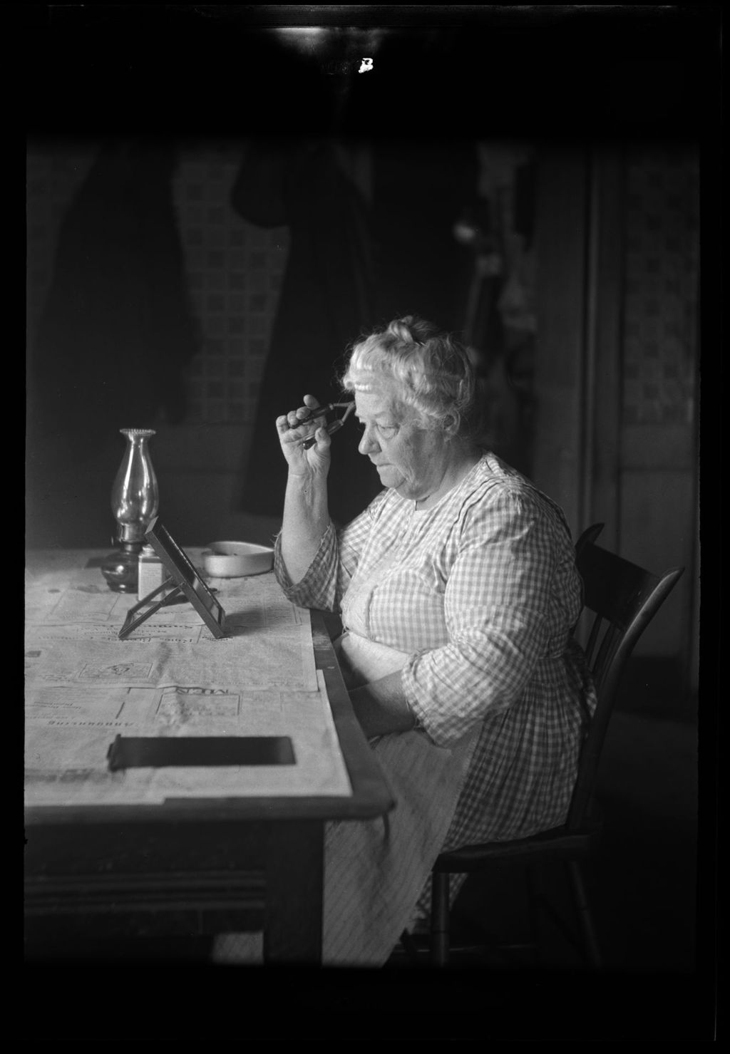 Miniature of Woman Sitting At A Table While Curling Her Hair