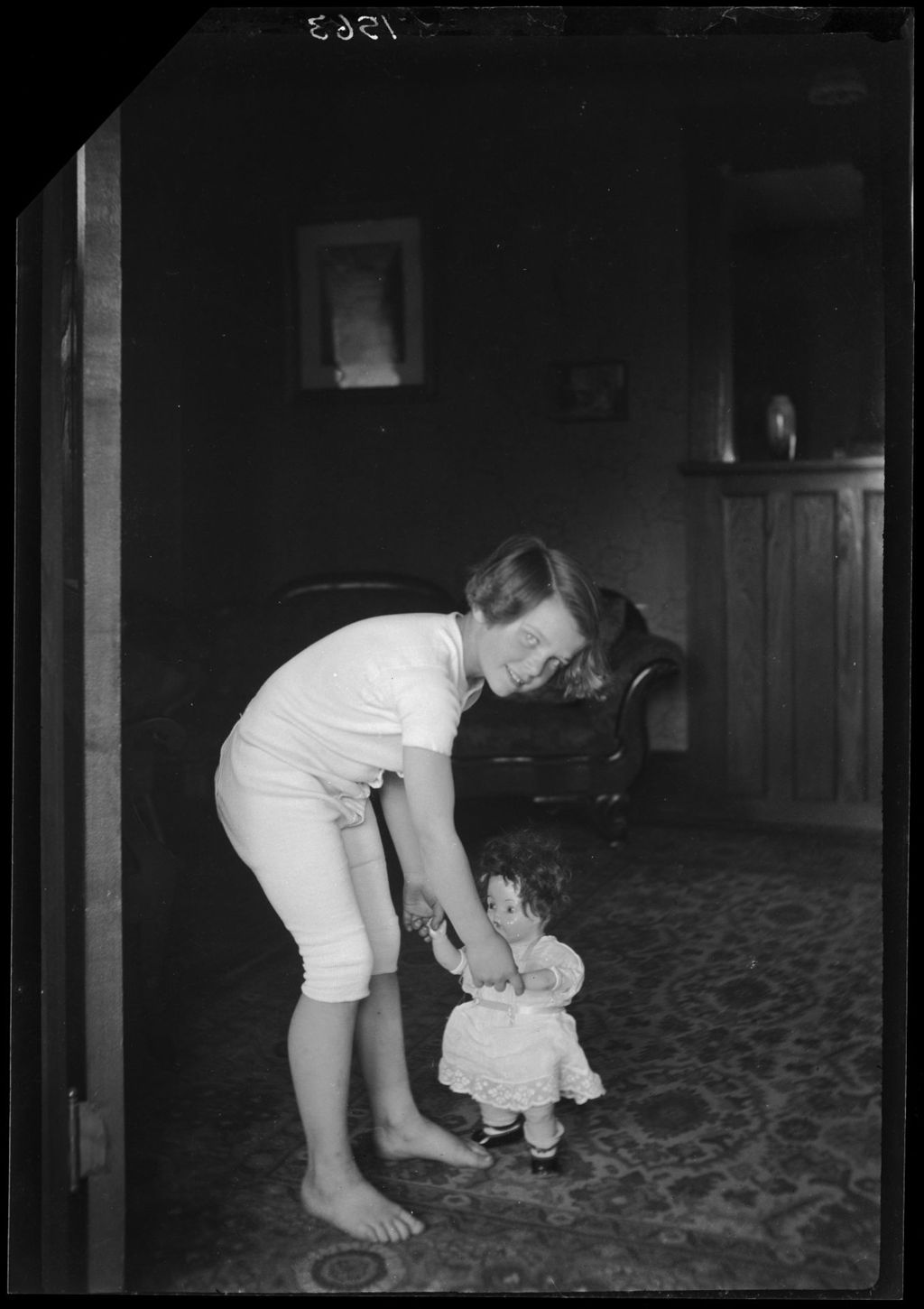 Miniature of Young Girl Playing With A Doll