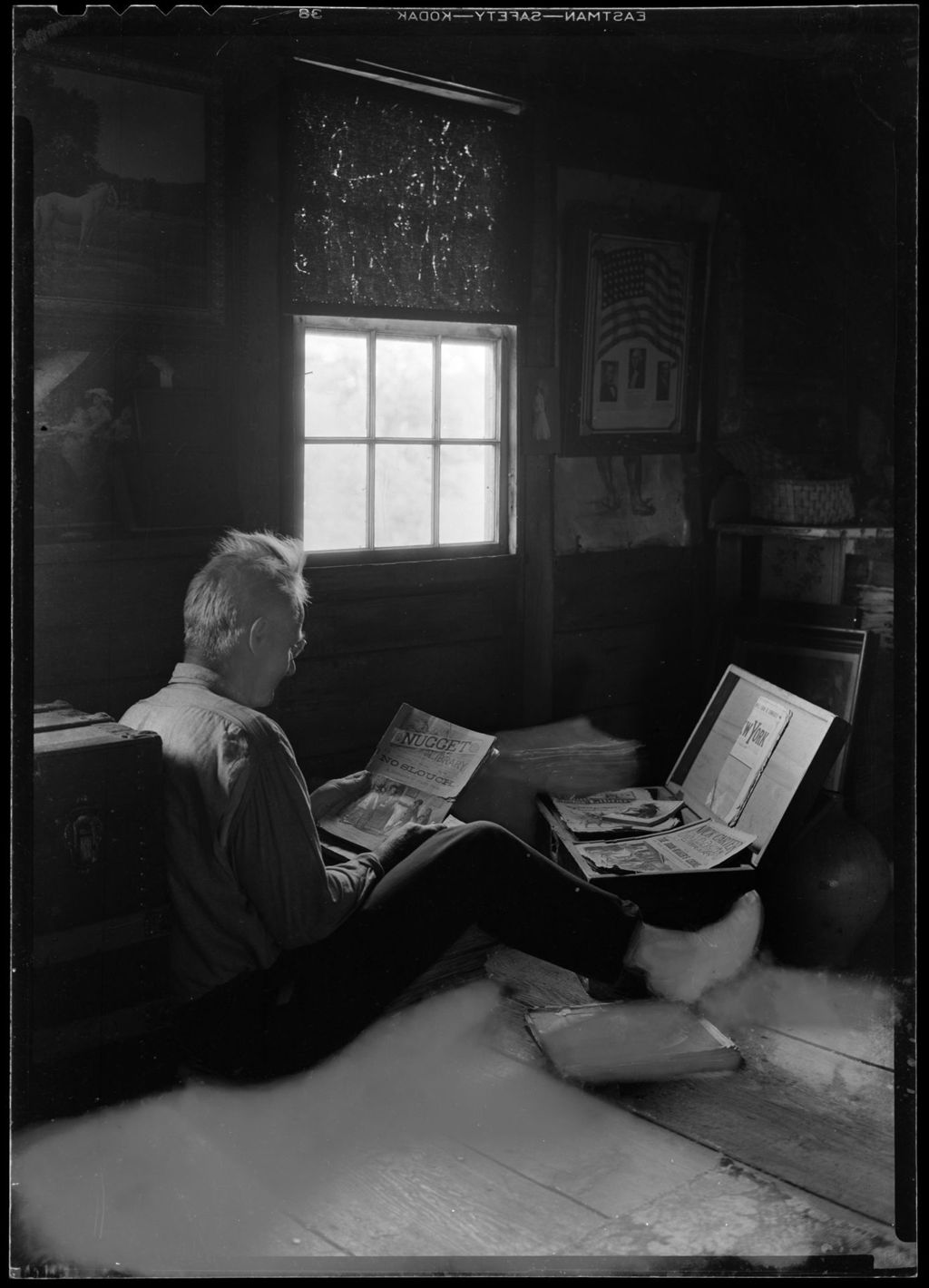 Miniature of George French Looking Over A Trunk Full Of Dime Novels.