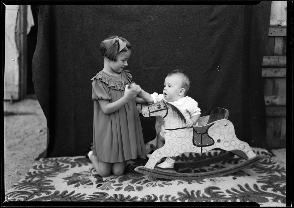 Miniature of Potrait Of A Yound Girl Beside A Baby In A Rocking Horse Chair