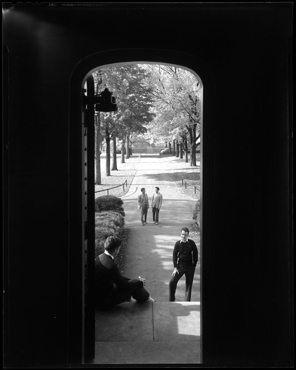 Miniature of View From Inside Door Looking Out And Down Long Tree Lined Sidewalk, With Students At Bates College