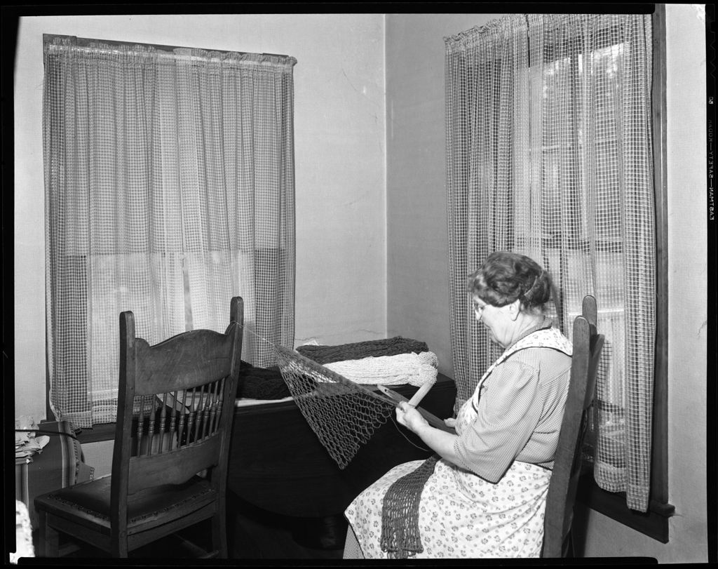 Miniature of Woman Sitting At A Table Working On A Doily