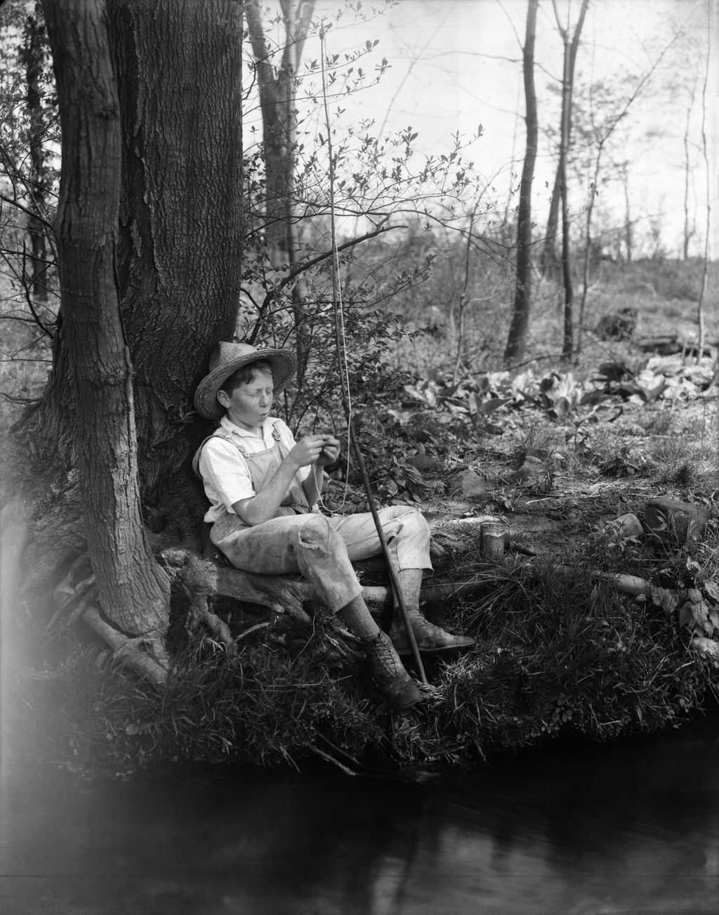 Miniature of Boy On Stream Bank With Bamboo Pole, Baiting His Hook, Typical Huck Finn, Tom Sawyer Shot