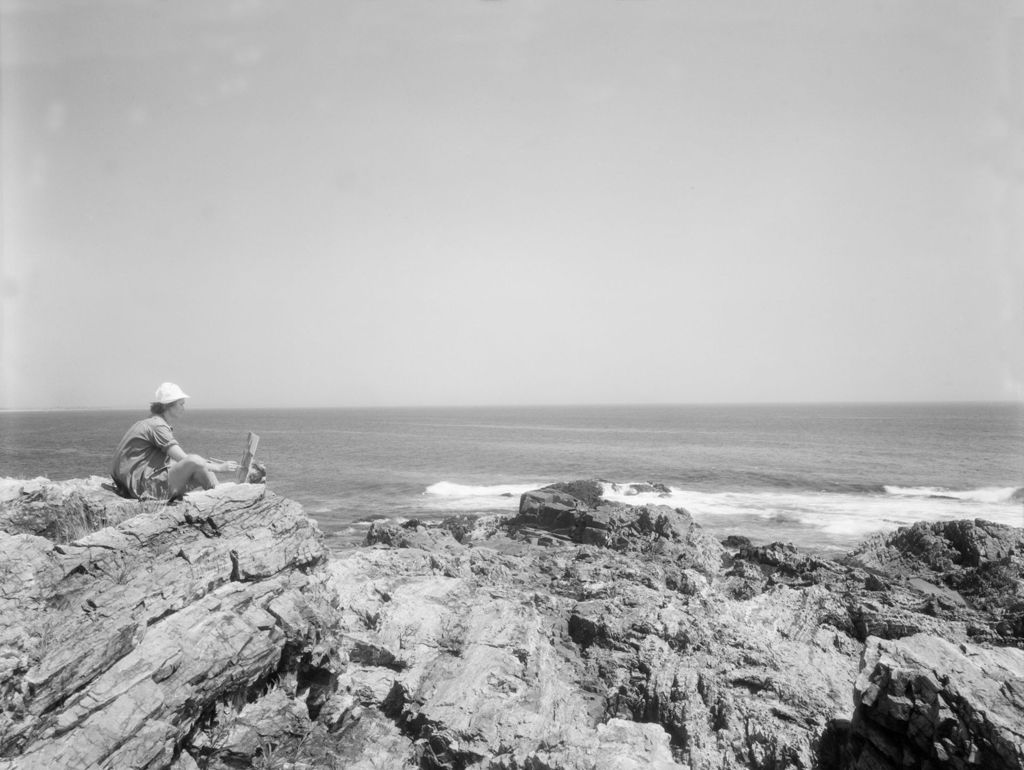 Miniature of Artist Left Sits On Rocks And Paints Ocean Scene In Ogunquit