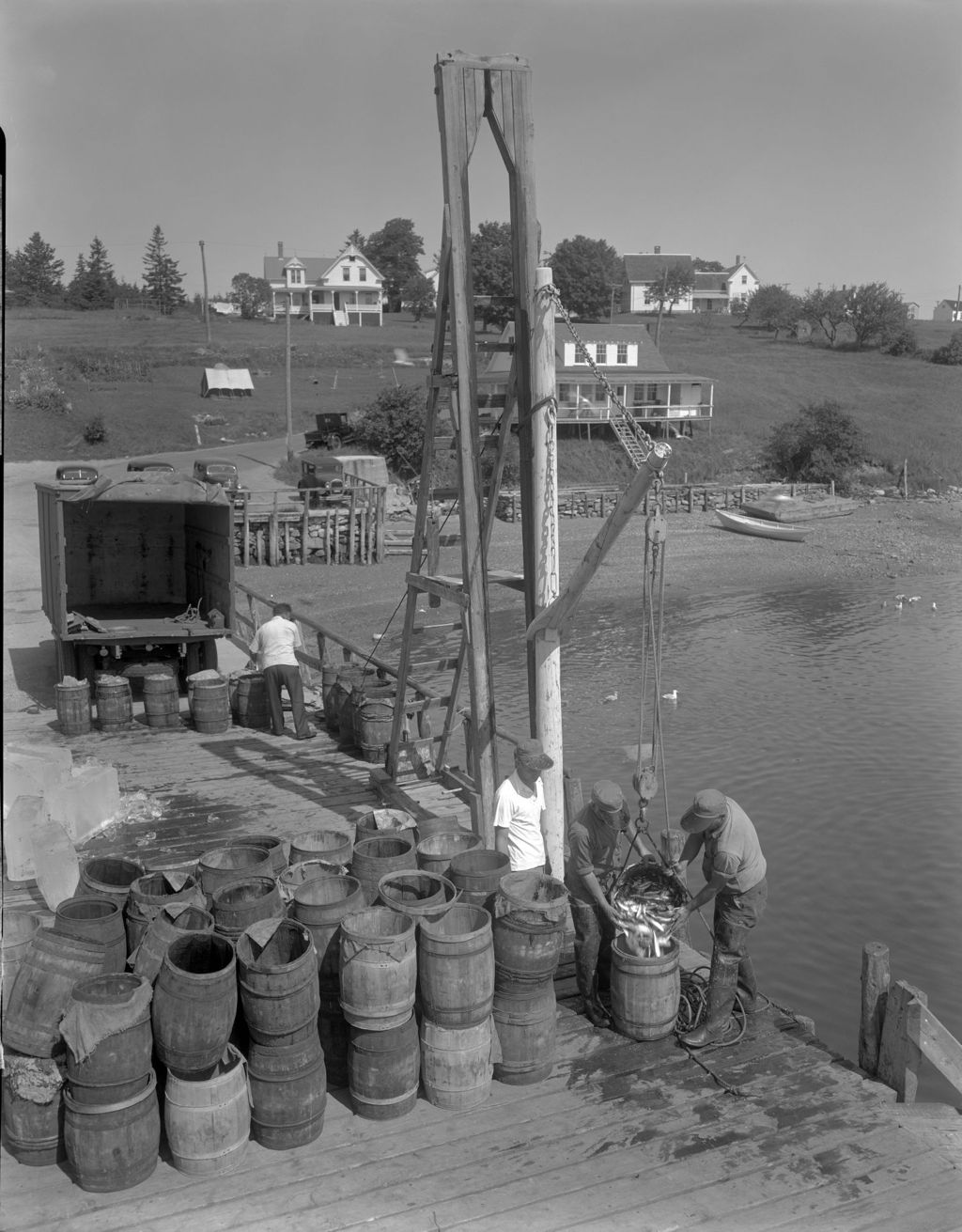 Miniature of Man Working On Pier Salting Down Fish And Preparing Them For Transport On A Truck