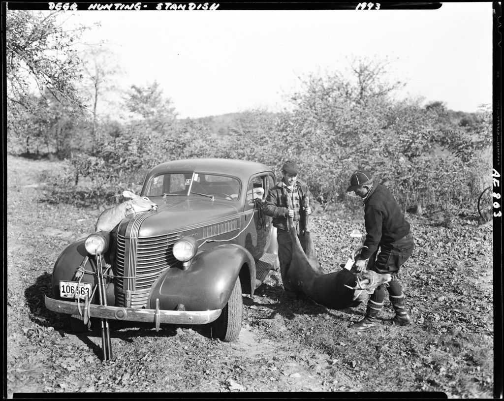 Miniature of Two Hunters Tying Two Deer On Fenders Of A Car--Standish