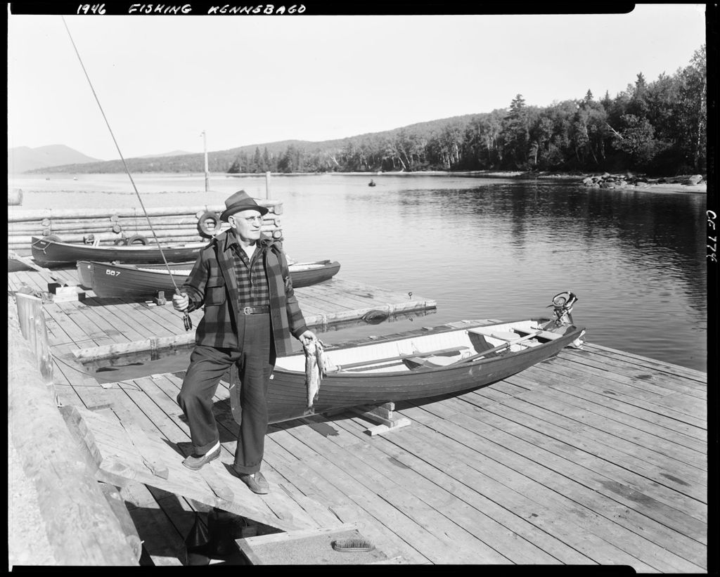 Miniature of Man Standing On A Dock At Kennebago Holding A Fishing Rod And A Couple Of Fish He Caught