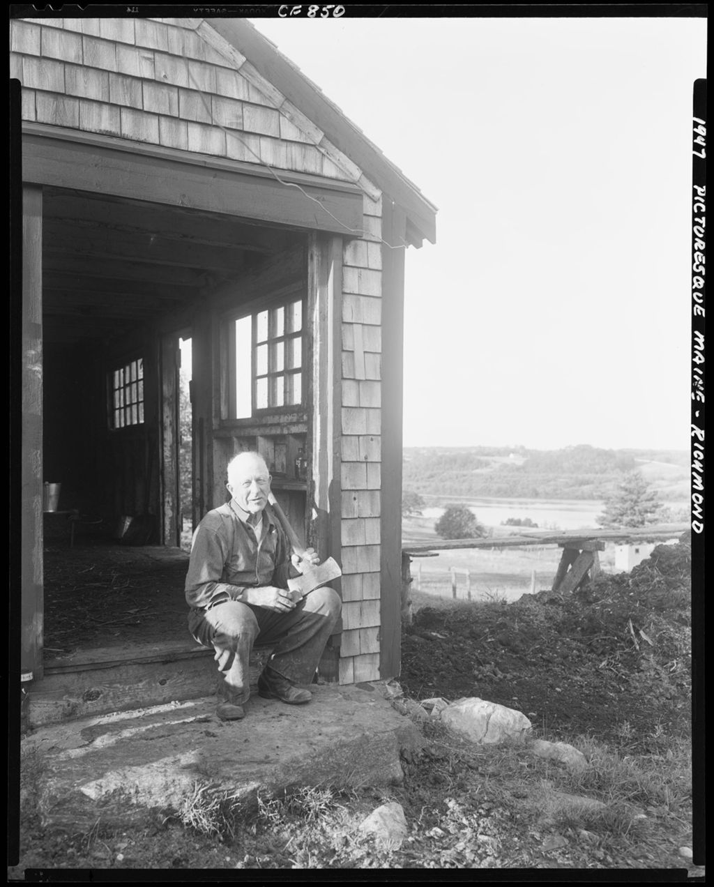 Miniature of Man [George Alba Alexander] Sitting In Doorway Of A Shop In Richmond Sharpening A Double Bitted Ax