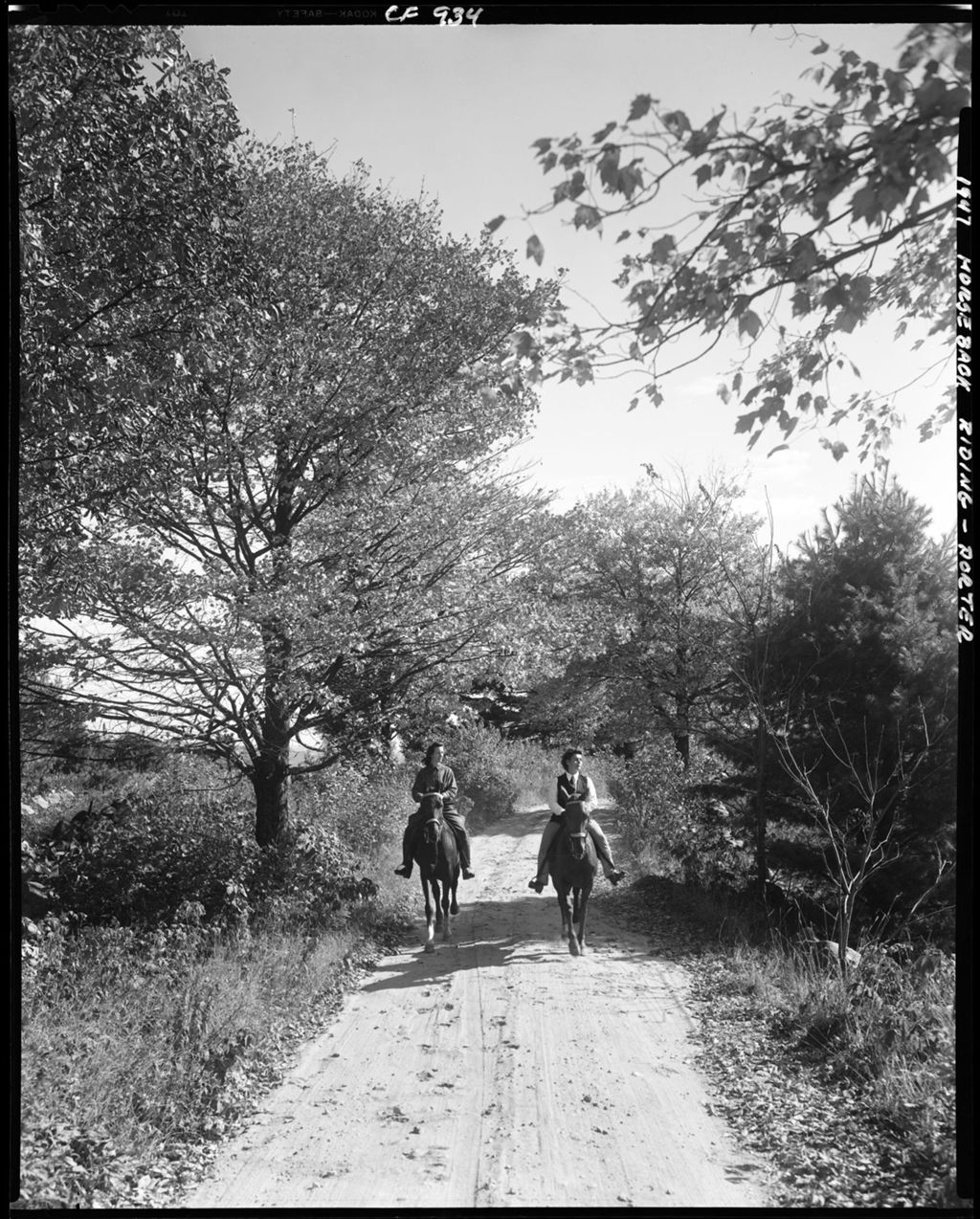 Miniature of Two Women Riding Horses Down A Gravel Road In Porter