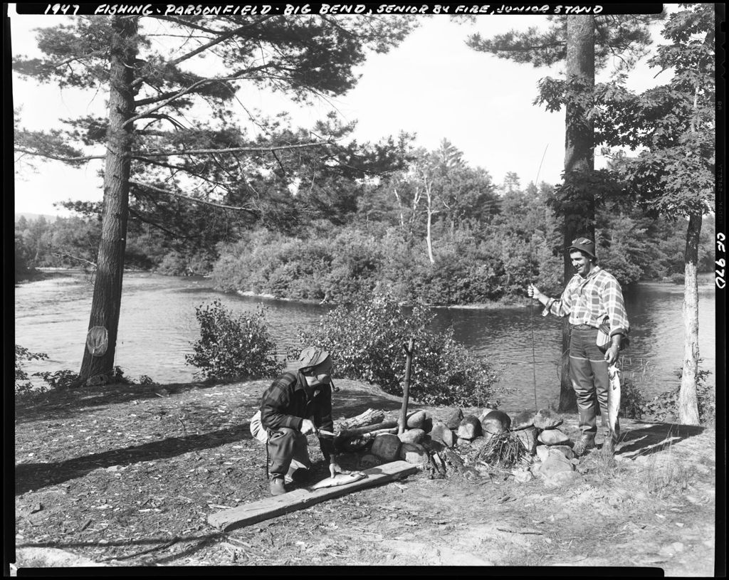 Miniature of Two Men At Campsite, One Holding Fish Other About To Fillet His In Parsonsfield
