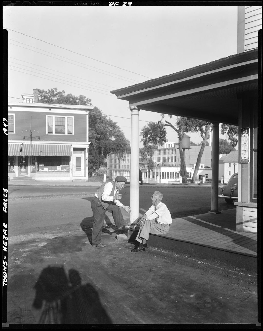 Miniature of Shot Of Two Old Timers Talking On Corner Of Porch In Middle Of Town, Factory In Background At Kezar Falls