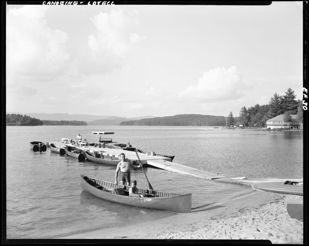 Miniature of Beached Canoe With Boy Sitting In Another In Water At Farrington's In Lovell