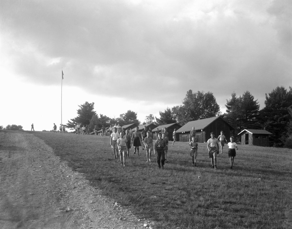 Miniature of Campers Walking In Front Of Camps