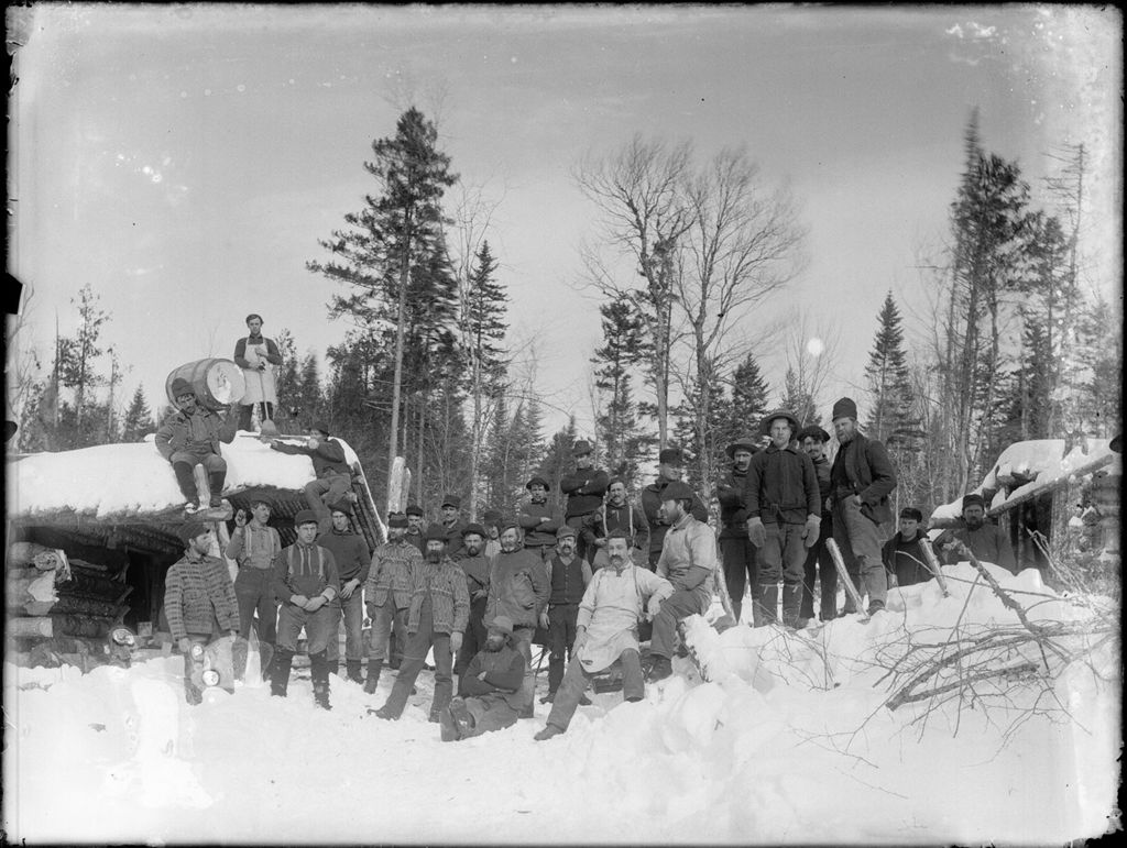 Miniature of Snow covered winter scene of many men at a logging camp