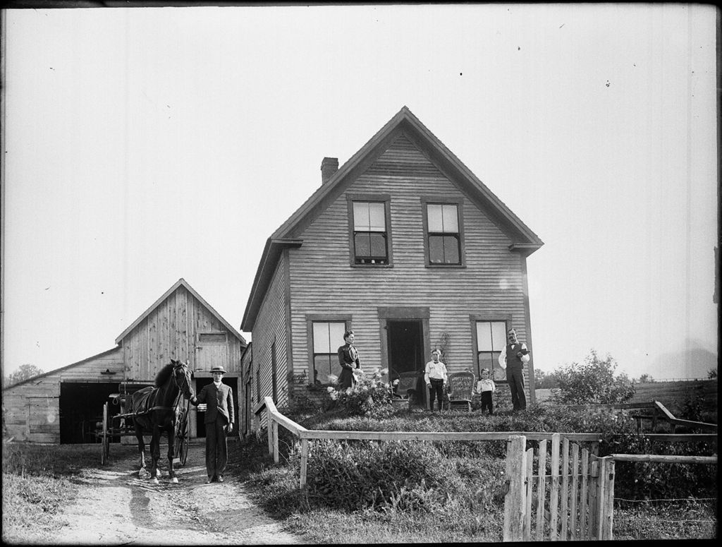 Miniature of Family posing outside their rural home and attached barn, young man stands beside a horse and carriage