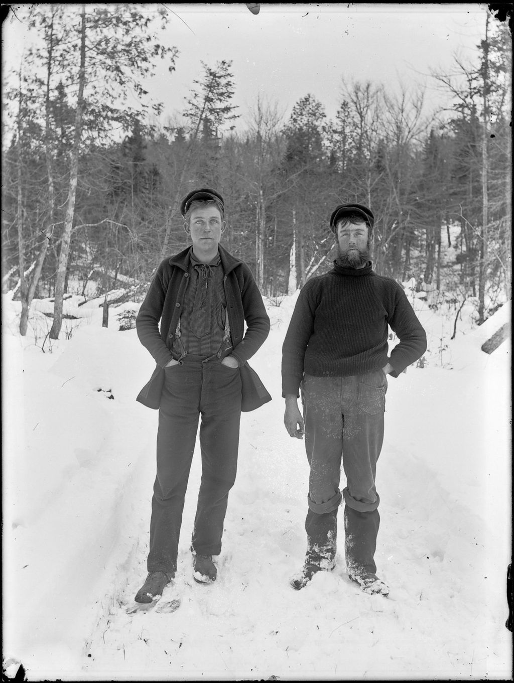 Miniature of Portrait of two young men from a logging camp standing outside in the woods