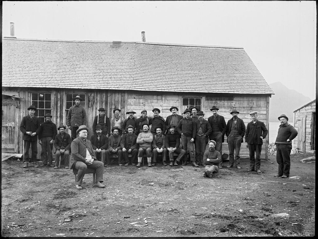 Miniature of Large group of men outside of a logging camp long house