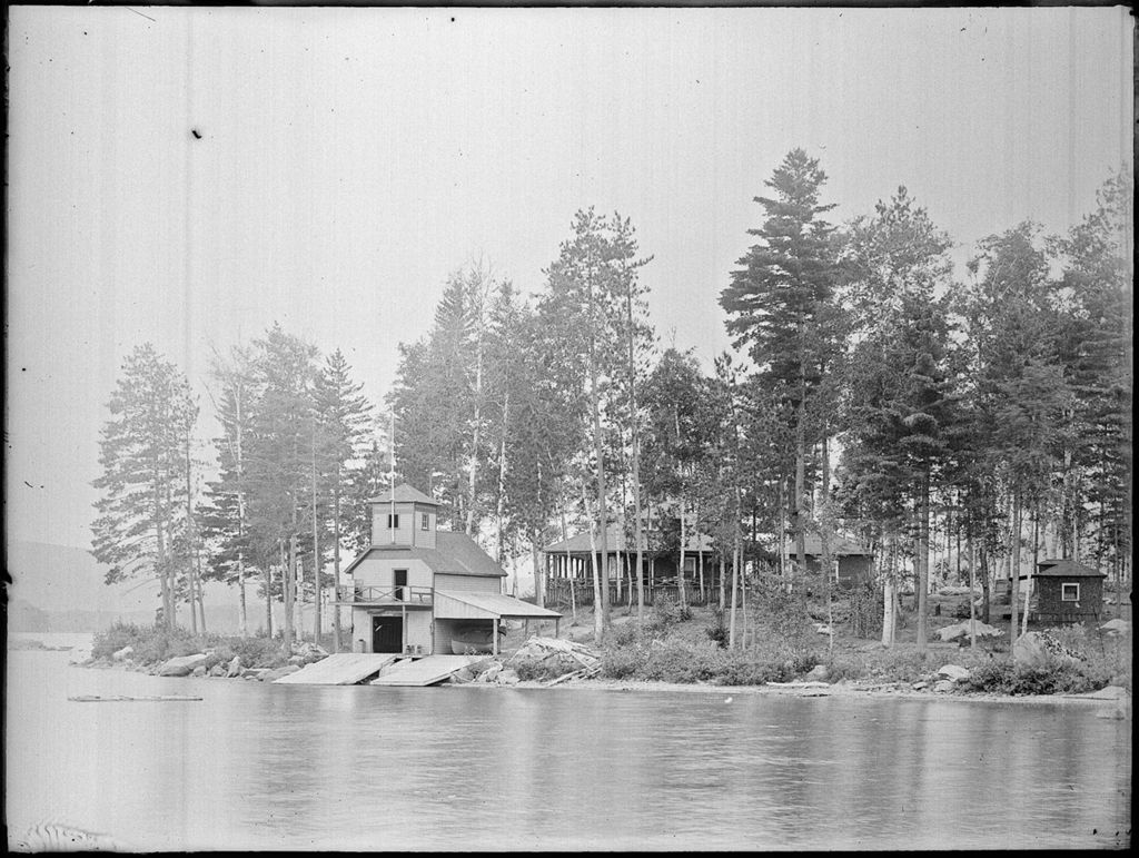 Miniature of Boathouse and home on a wooded lakeside point