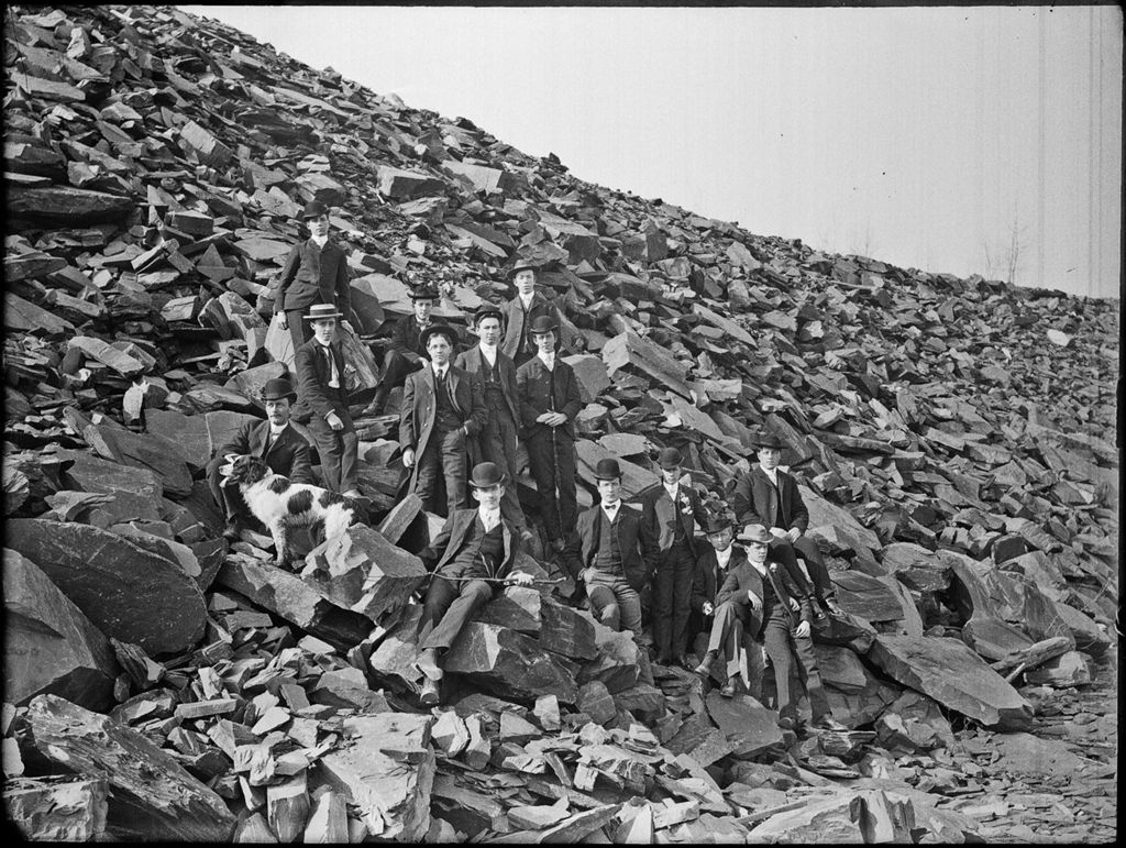 Miniature of Group of well dressed men on the slope of rock strewn hillside