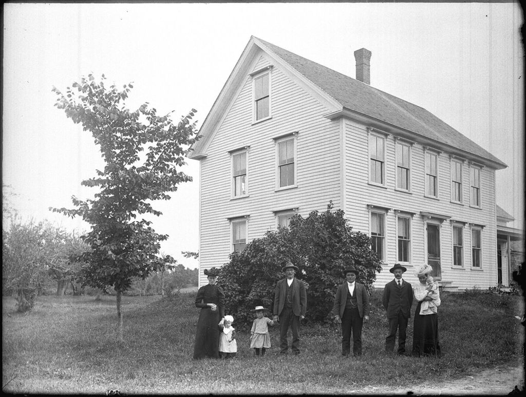 Miniature of Family with three children posed outside of their rural, two story, home