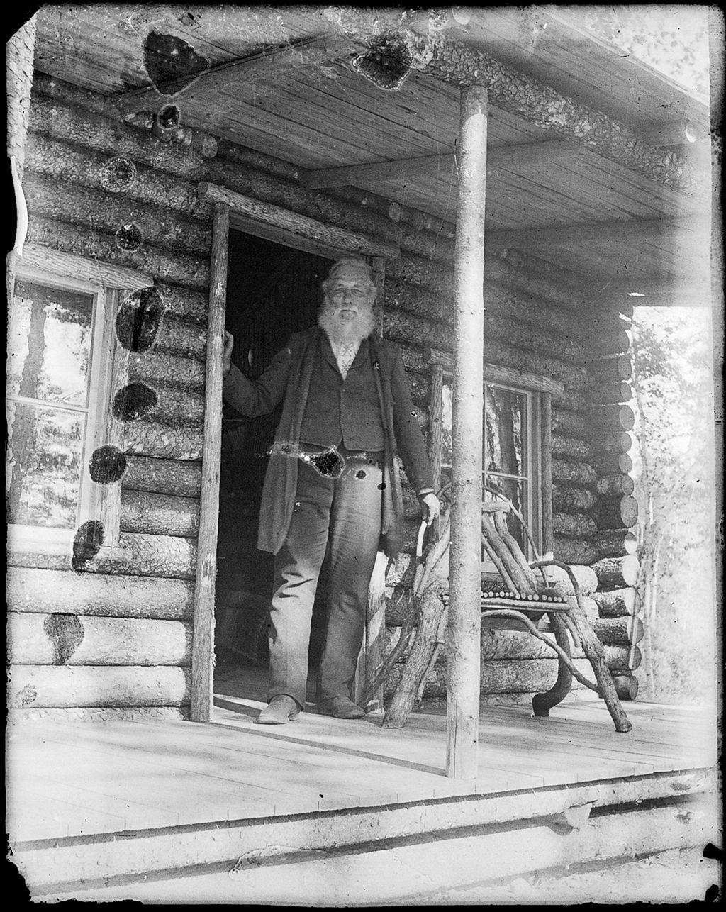 Miniature of Elderly, bearded man standing in the doorway of a log cabin