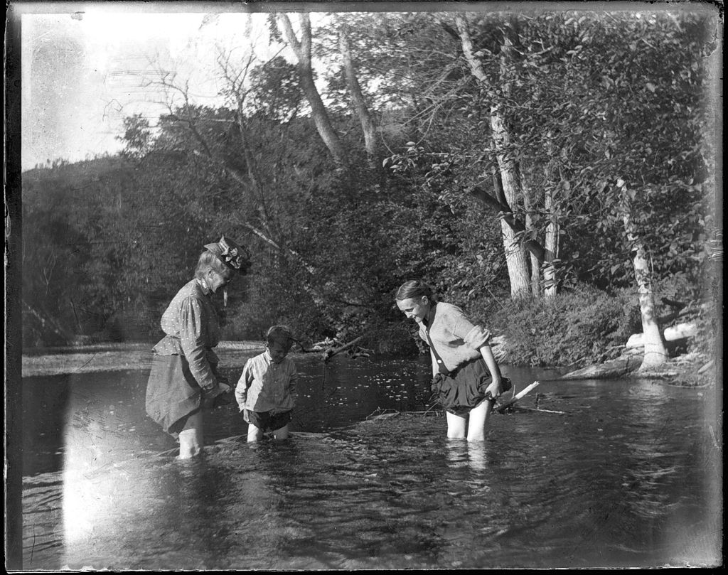 Miniature of Woman with a young boy and girl standing knee deep in a lake