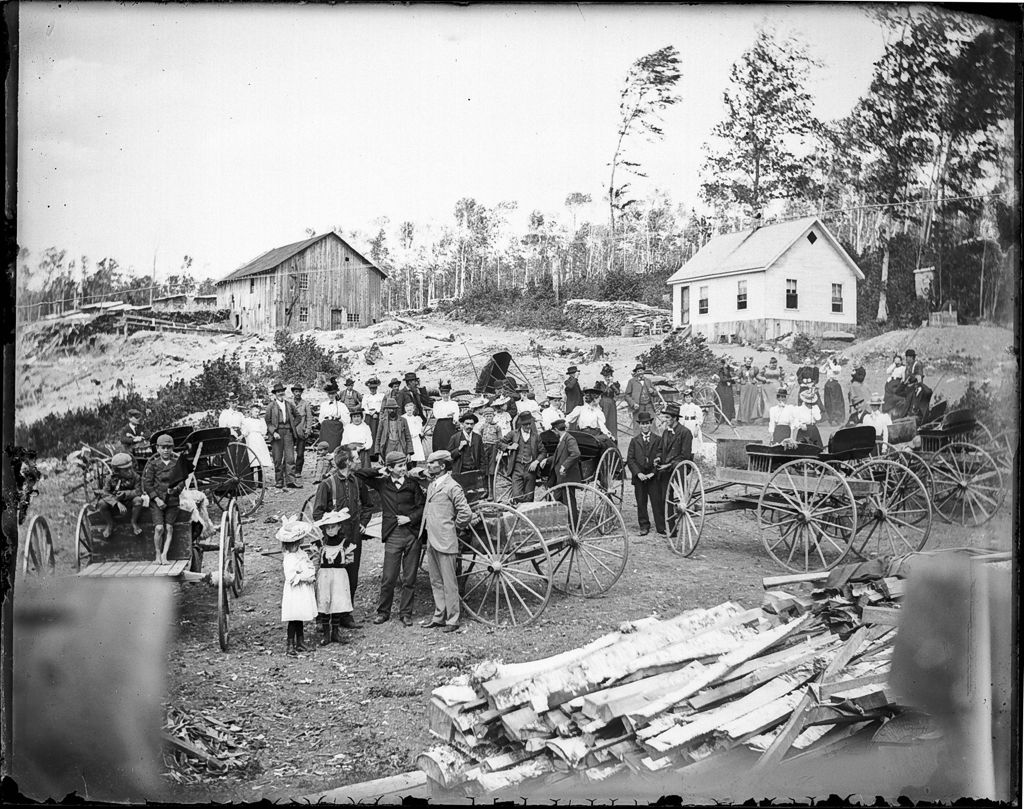 Miniature of Large group of people gathered outside of town at a lumber mill